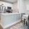 kitchen and dining areas with bright lighting