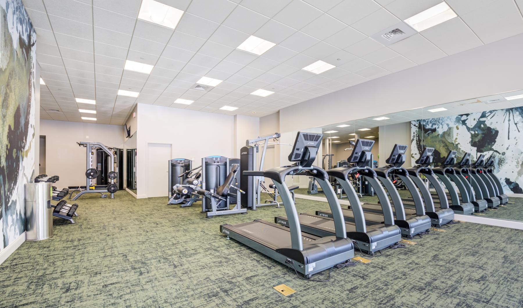 State-of-the-art amenities a gym with exercise equipment