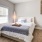 large windows brighten spacious bedroom